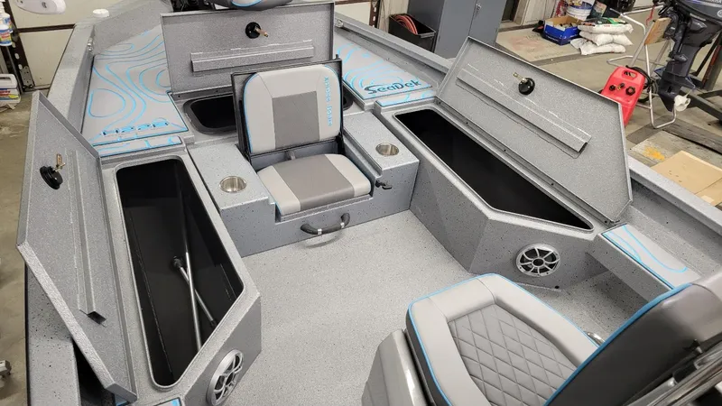 Slide: The Image of 2025 Xpress H22 Bay boat interior with storage compartments and seating. - 6