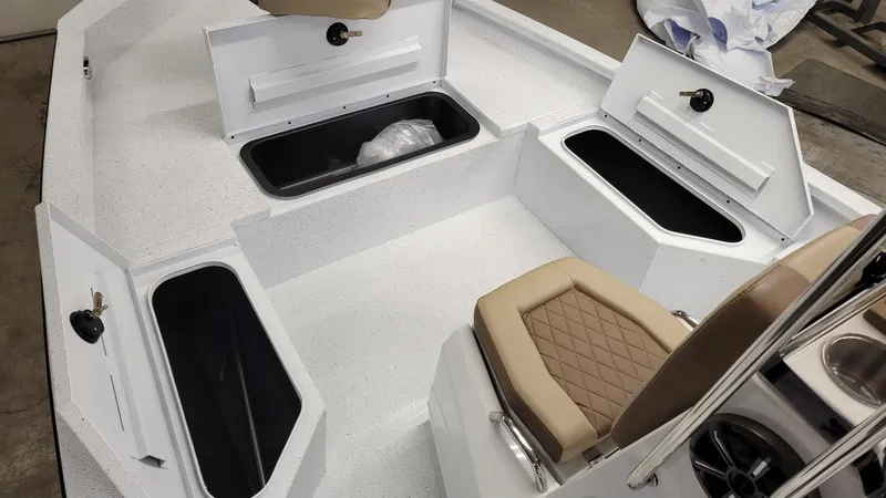 Slide: The Image of 2025 Xpress H20 Bay boat interior with storage compartments and seating. - 13