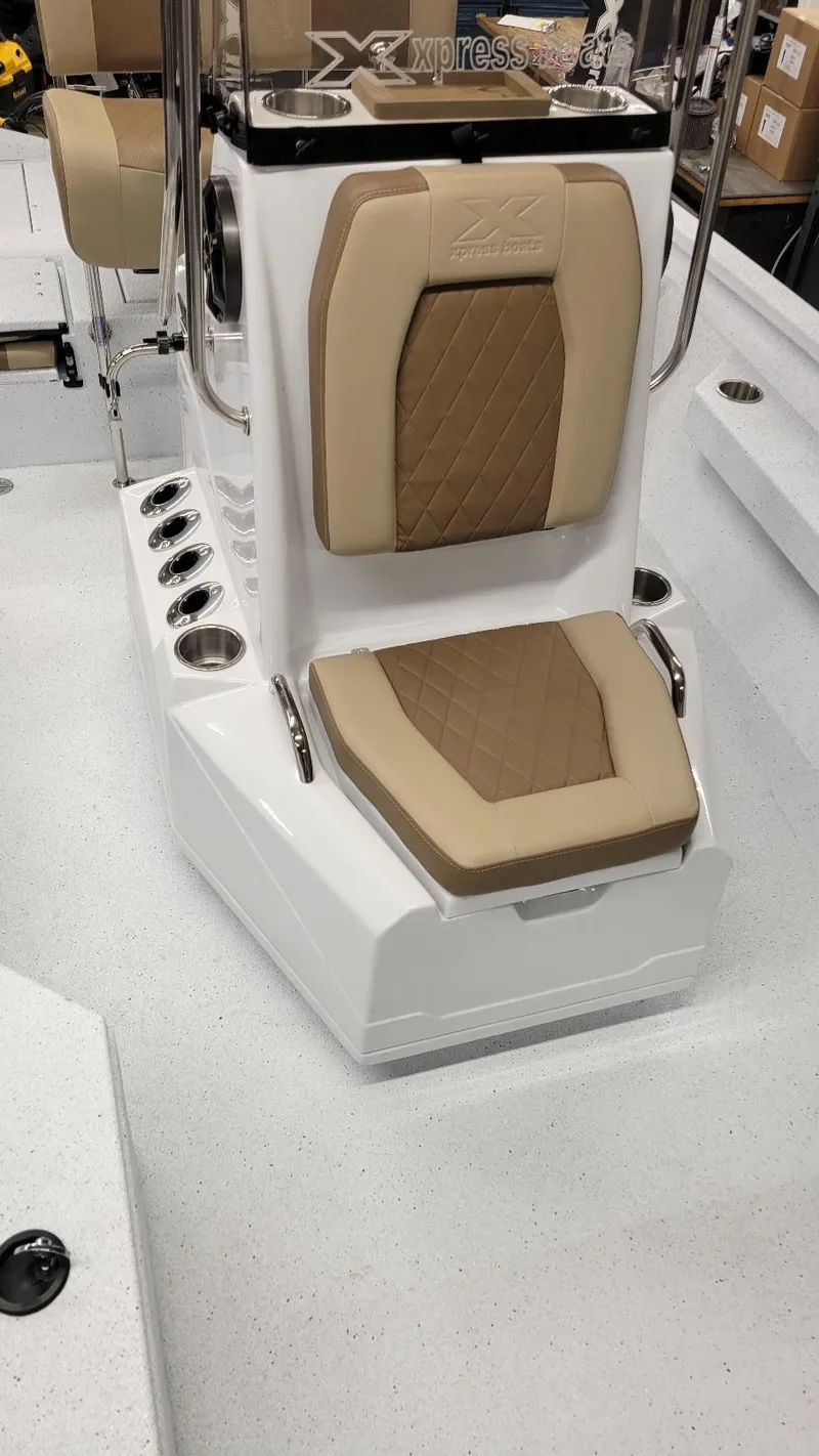 Slide: The Image of 2025 Xpress H20 Bay boat interior with tan seating and console details. - 15