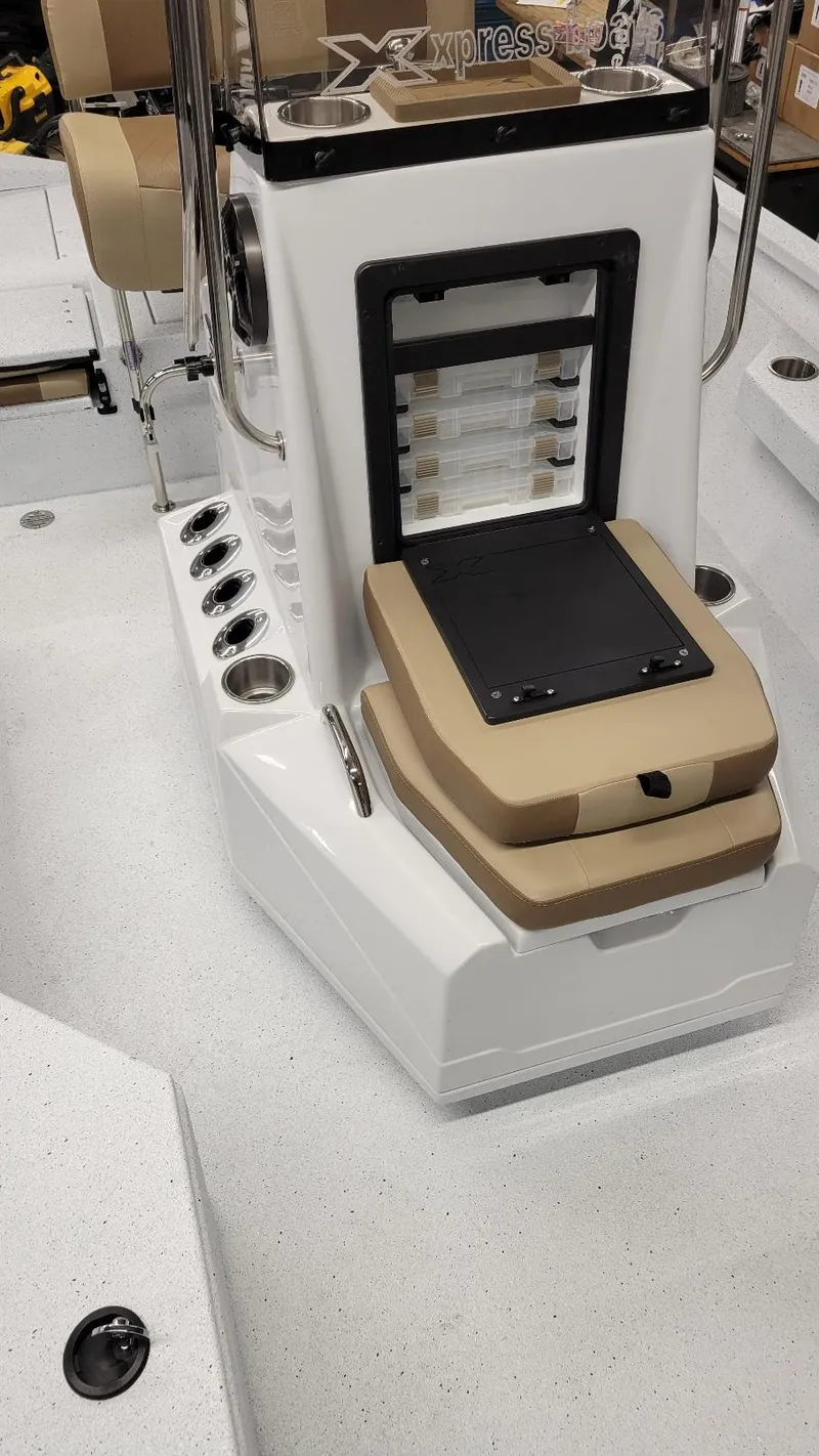Slide: The Image of 2025 Xpress H20 Bay boat interior with seating and storage compartments. - 16