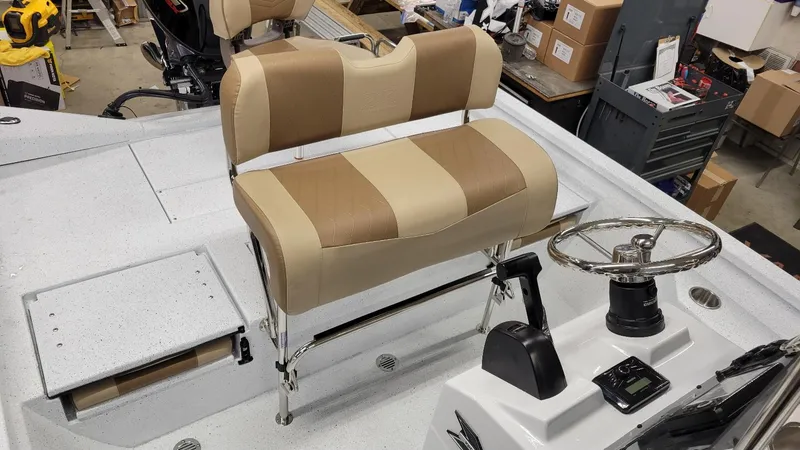 Slide: The Image of 2025 Xpress H20 Bay boat interior with Yamaha Vmax 115 SHO, featuring steering console and seating. - 17