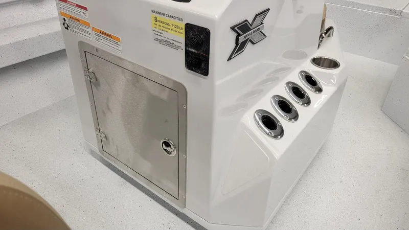 Slide: The Image of 2025 Xpress H20 Bay boat console with storage and cup holders. - 19