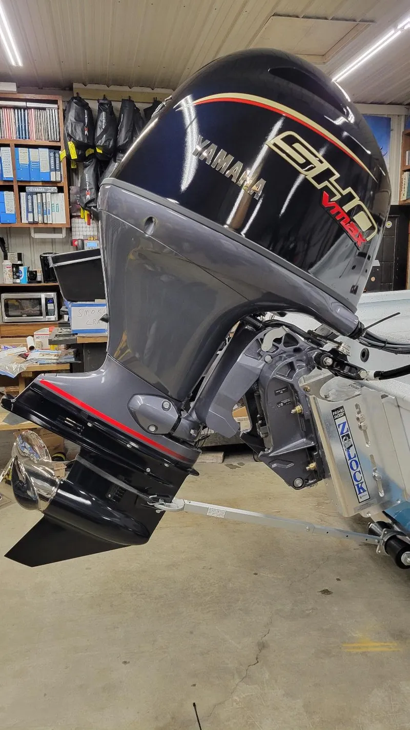 Slide: The Image of 2025 Xpress H20 Bay with Yamaha Vmax 115 SHO outboard motor in a workshop setting. - 3