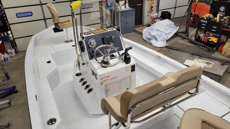 Slide: The Image of 2025 Xpress H20 Bay boat with Yamaha Vmax 115 SHO, interior view in garage. - 4