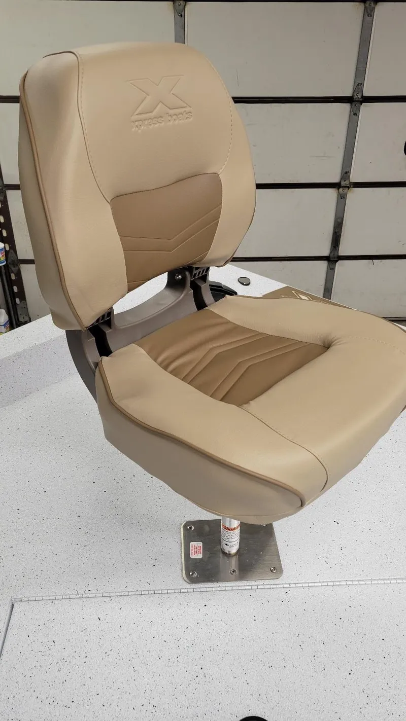 Slide: The Image of 2025 Xpress H20 Bay boat seat with beige upholstery and sturdy base. - 5
