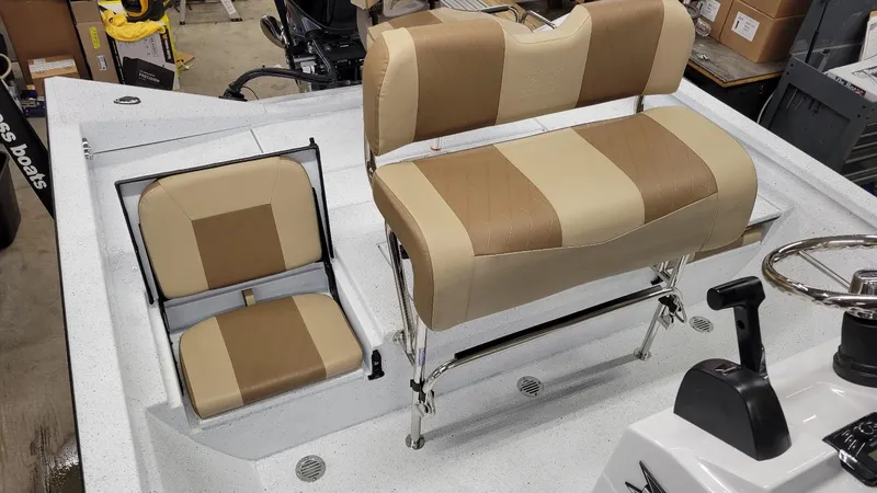 Slide: The Image of 2025 Xpress H20 Bay boat interior with beige seating and steering console. - 6