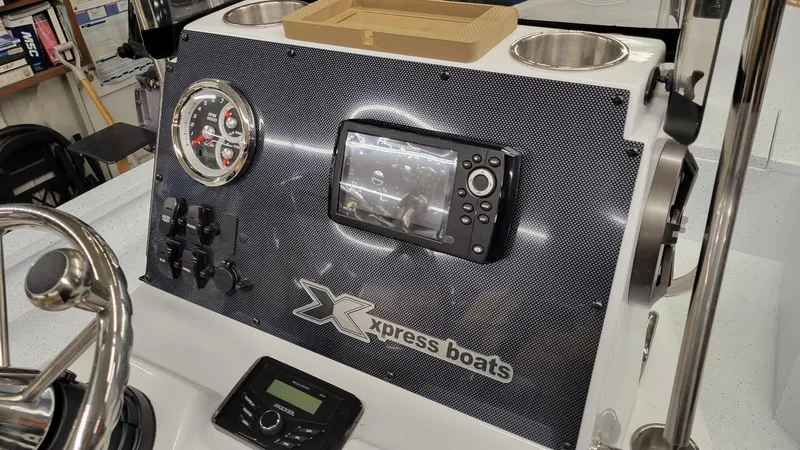Slide: The Image of 2025 Xpress H20 Bay boat dashboard with Yamaha Vmax 115 SHO controls. - 8