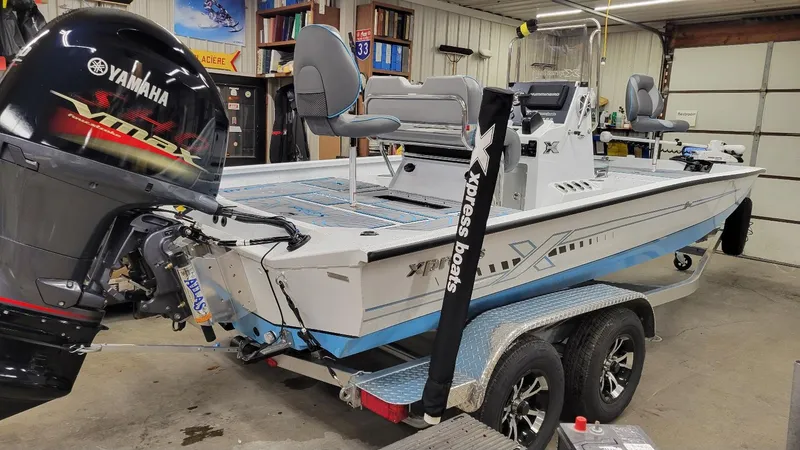 Slide: The Image of 2025 Xpress H20 Bay boat with Yamaha Vmax 150 SHO engine in a garage setting. - 12