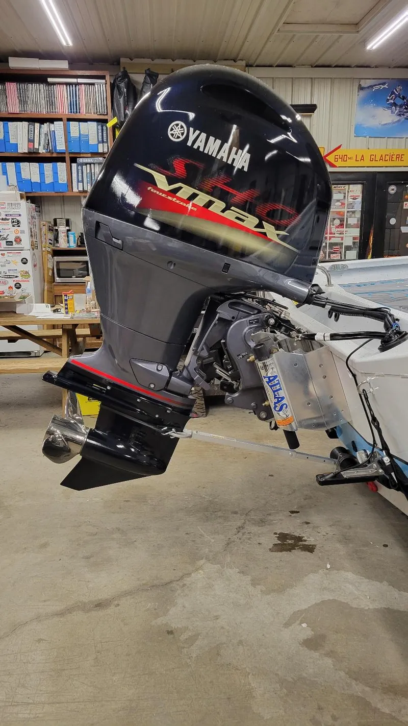 Slide: The Image of 2025 Xpress H20 Bay with Yamaha Vmax 150 SHO outboard motor in a workshop. - 13