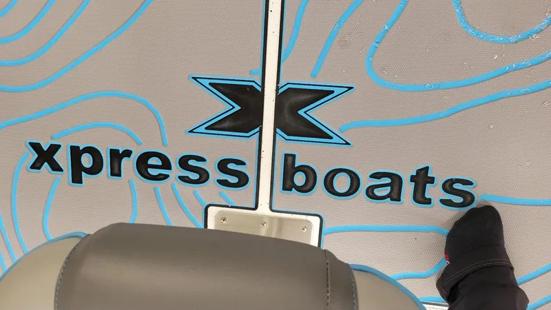 Slide: The Image of 2025 Xpress H20 Bay boat deck with logo and foot visible. - 17