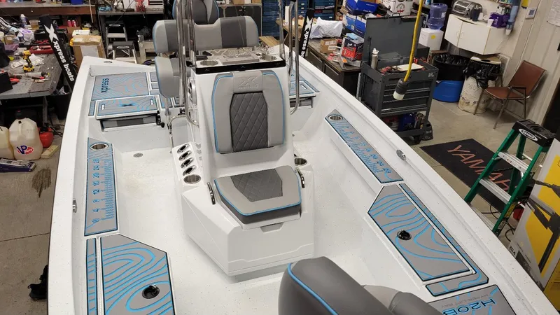Slide: The Image of 2025 Xpress H20 Bay boat interior with Yamaha Vmax 150 SHO, featuring sleek seating and storage. - 18