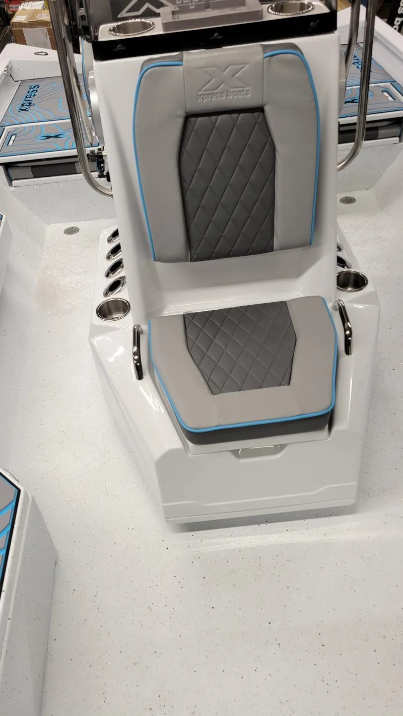 Slide: The Image of 2025 Xpress H20 Bay boat interior with gray and blue seating, featuring Yamaha Vmax 150 SHO. - 19