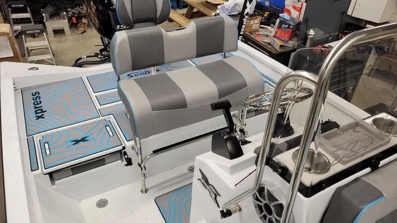 Slide: The Image of 2025 Xpress H20 Bay boat interior with Yamaha Vmax 150 SHO engine, featuring seating and controls. - 20