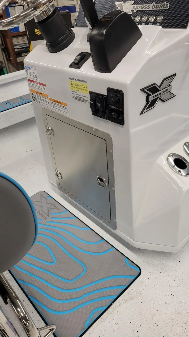 Slide: The Image of 2025 Xpress H20 Bay boat interior with Yamaha Vmax 150 SHO, featuring control panel and storage. - 23