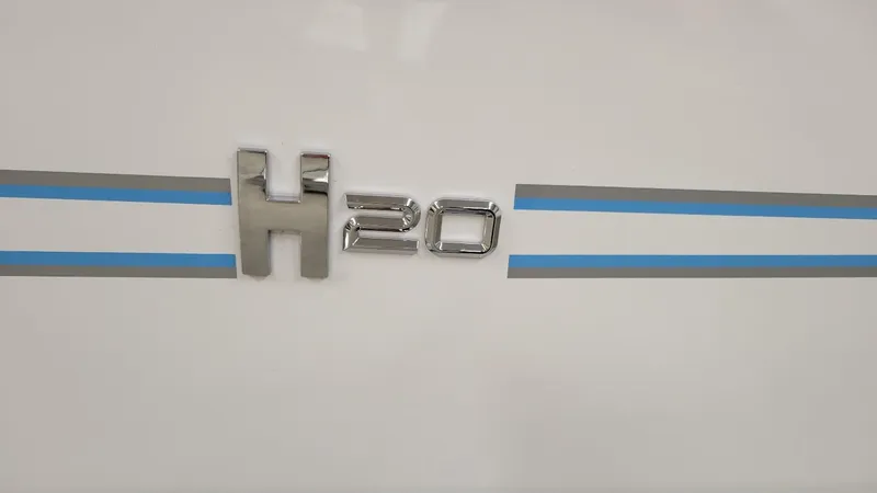 Slide: The Image of 2025 Xpress H20 Bay boat emblem with blue and gray stripes. - 3