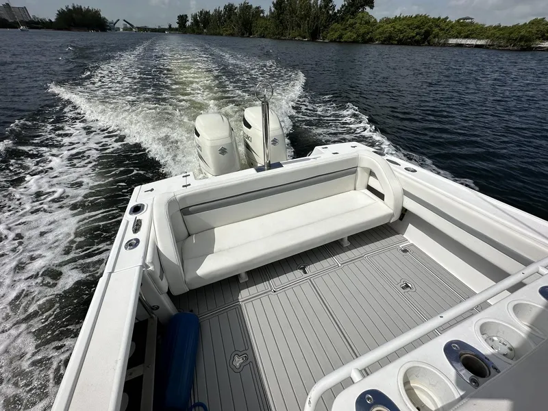 Slide: The Image of 2003 Intrepid 32 boat cruising on a lake with twin engines and spacious seating. - 15