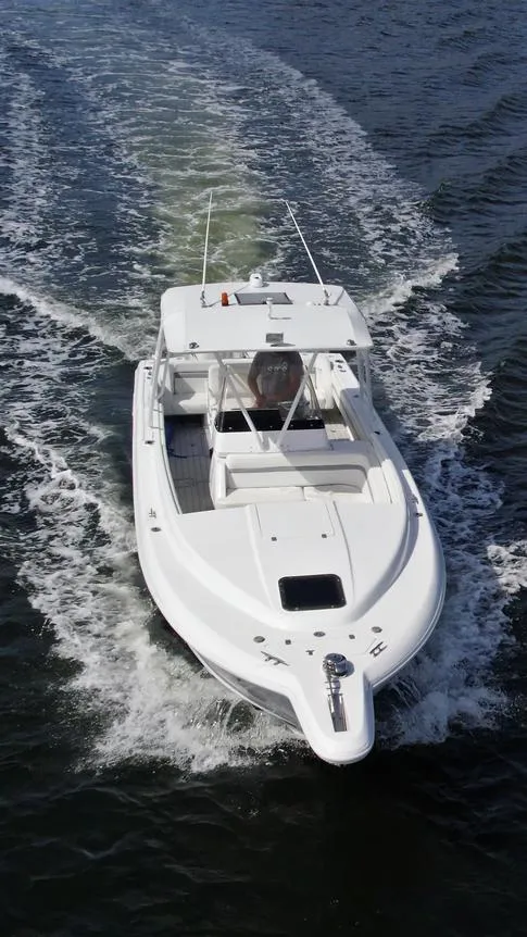 Slide: The Image of 2003 Intrepid 32 boat cruising on open water, aerial view. - 18