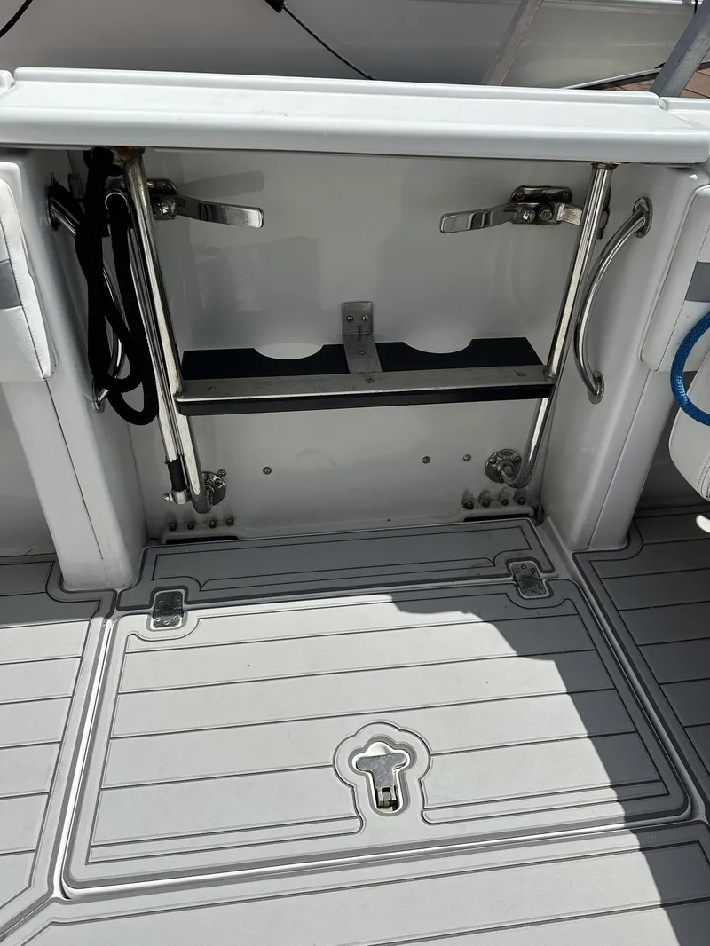 Slide: The Image of 2003 Intrepid 32 boat deck with storage compartment and stainless steel fittings. - 31