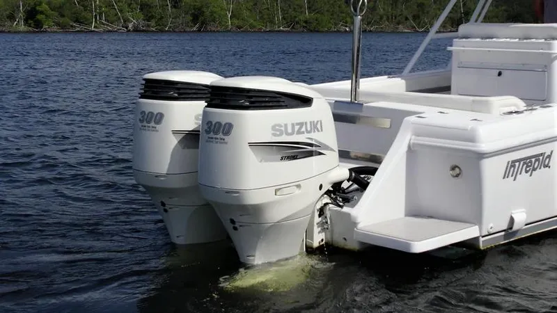 Slide: The Image of 2003 Intrepid 32 boat with twin Suzuki 300 outboard engines on water. - 36