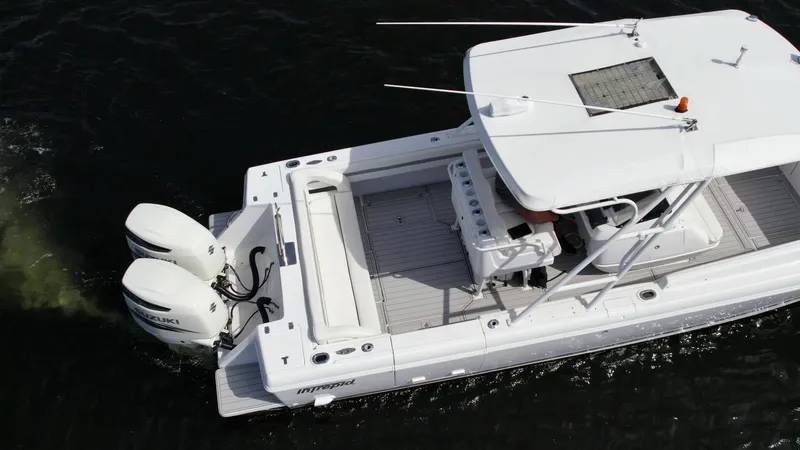 Slide: The Image of 2003 Intrepid 32 boat with dual Suzuki outboard engines on water. - 38