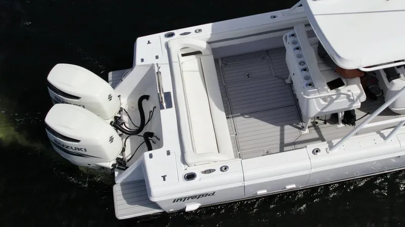 Slide: The Image of 2003 Intrepid 32 boat with dual Suzuki outboard engines on water. - 39