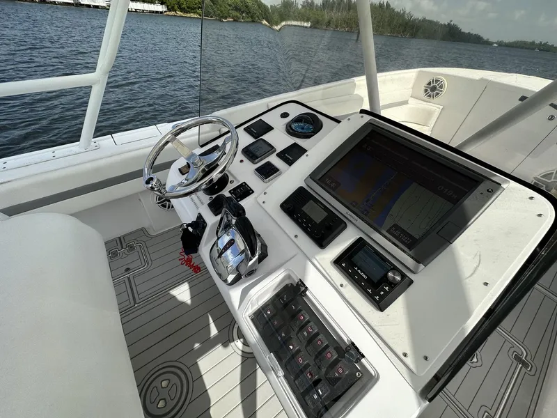 Slide: The Image of Cockpit of 2003 Intrepid 32 boat with modern navigation equipment and steering wheel. - 4