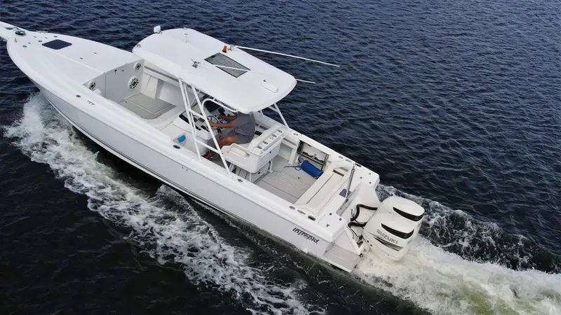 Slide: The Image of 2003 Intrepid 32 boat cruising on open water, aerial view. - 42