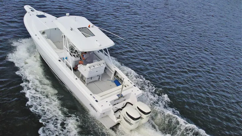 Slide: The Image of 2003 Intrepid 32 boat cruising on open water, aerial view. - 43
