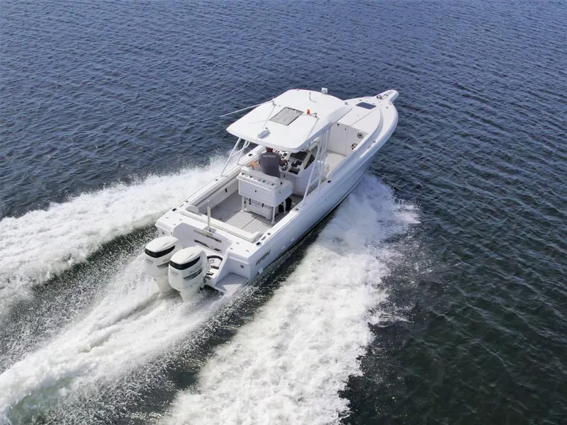 Slide: The Image of 2003 Intrepid 32 boat cruising on open water with twin engines. - 45