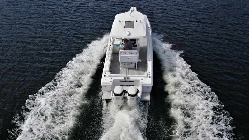 Slide: The Image of 2003 Intrepid 32 boat cruising on open water, rear view. - 46