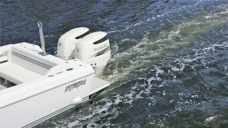 Slide: The Image of 2003 Intrepid 32 boat with Suzuki engines cruising on water. - 6