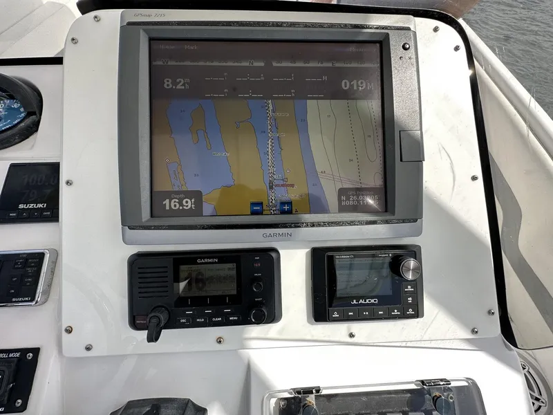 Slide: The Image of Dashboard of a 2003 Intrepid 32 boat featuring navigation and communication equipment. - 13
