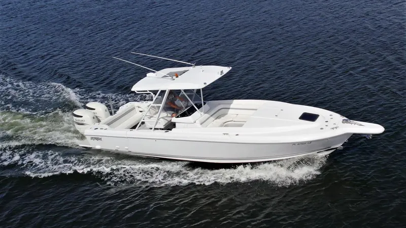 Slide: The Image of 2003 Intrepid 32 boat cruising on open water, side view. - 19