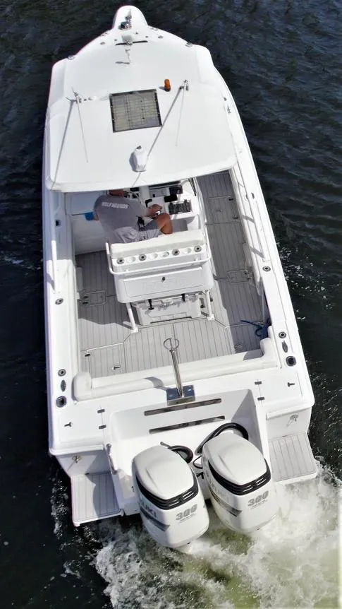 Slide: The Image of 2003 Intrepid 32 boat with dual engines cruising on water. - 2