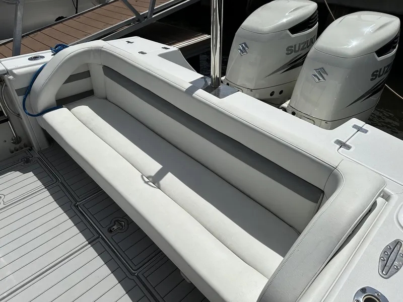 Slide: The Image of 2003 Intrepid 32 boat with white seating and dual Suzuki outboard motors. - 33