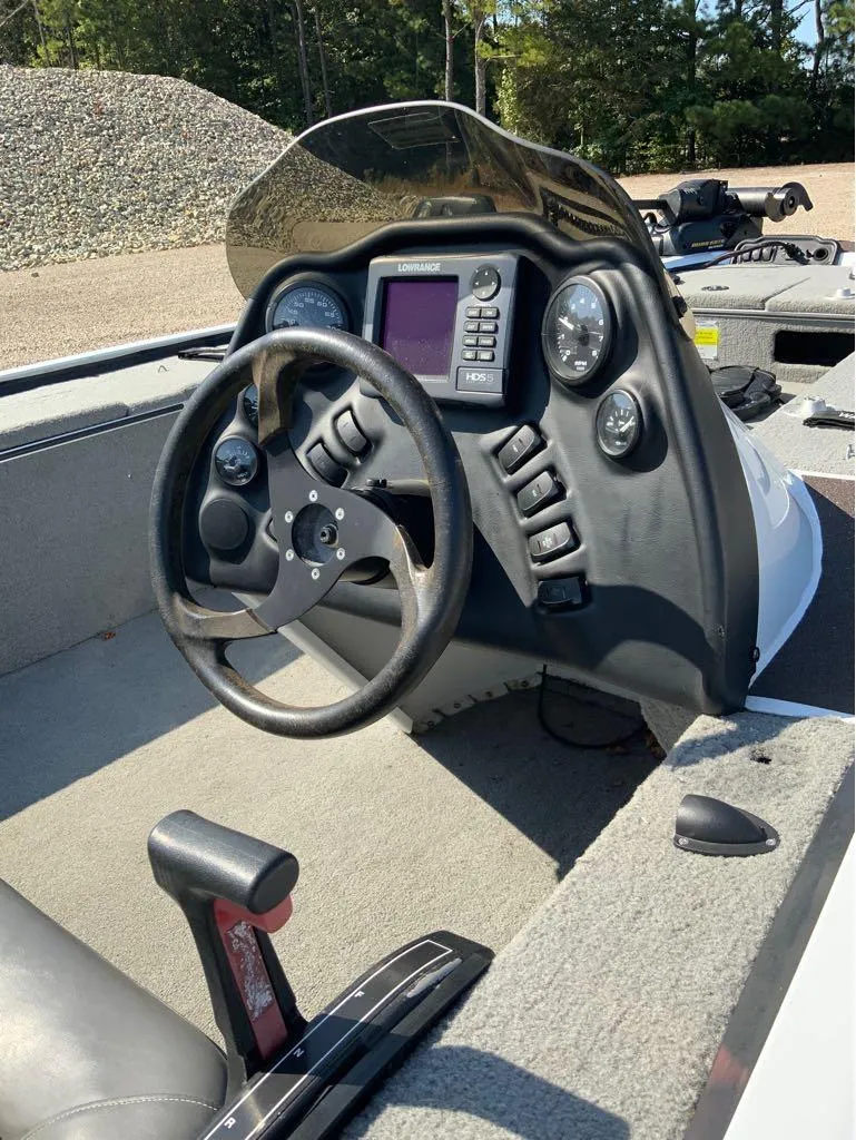 Slide: The Image of War Eagle Predator 861 boat dashboard with steering wheel and control panel, 2011 model. - 5