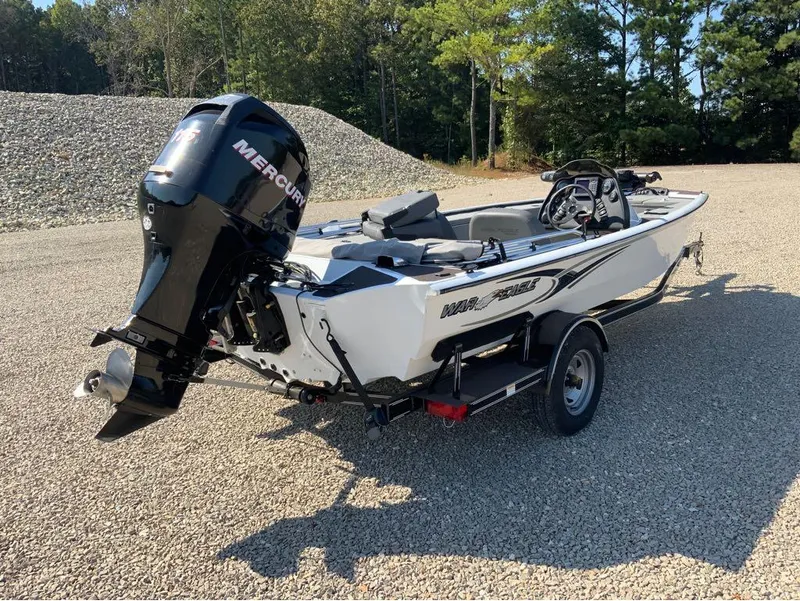 Slide: The Image of 2011 War Eagle Predator 861 boat with Mercury outboard motor on gravel lot. - 7