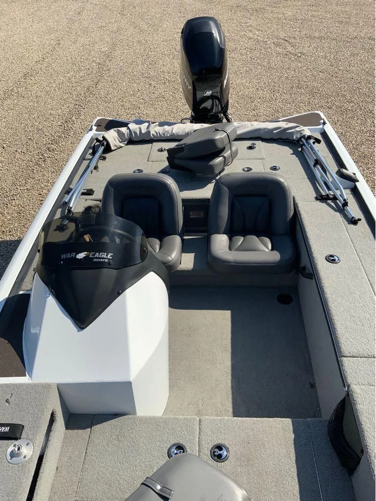 Slide: The Image of 2011 War Eagle Predator 861 boat interior with dual seats and motor. - 9
