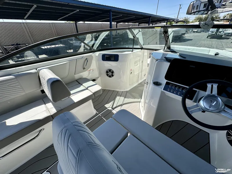 Slide: The Image of 2025 Sea Ray SDX 250 Surf boat interior with modern seating and steering wheel. - 12