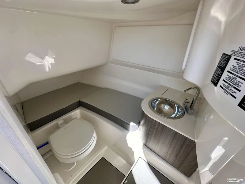 Slide: The Image of 2025 Sea Ray SDX 250 Surf boat interior with toilet and sink. - 14