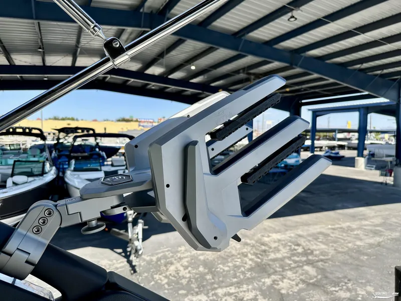 Slide: The Image of 2025 Sea Ray SDX 250 Surf boat rack under a covered marina. - 16