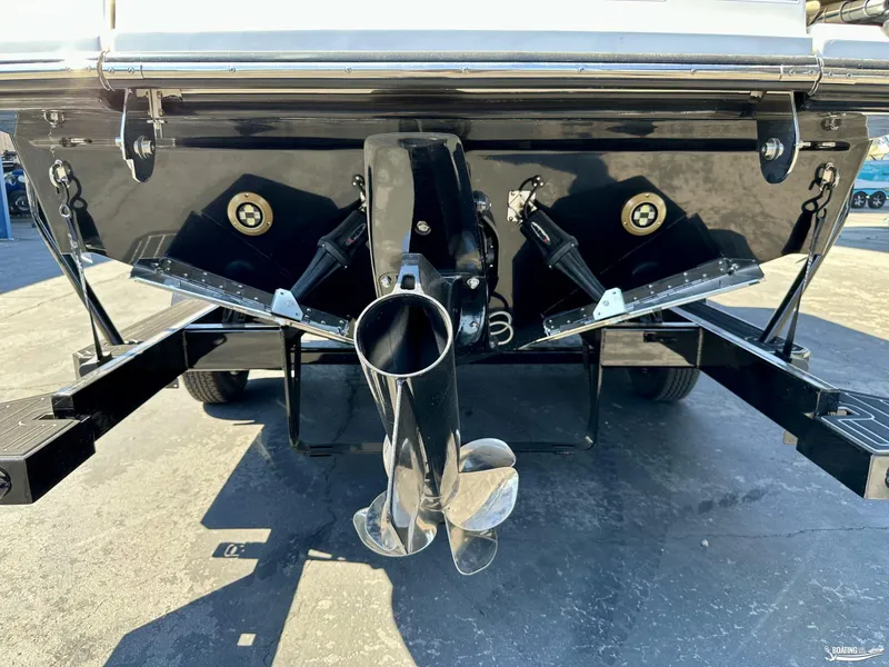 Slide: The Image of 2025 Sea Ray SDX 250 Surf boat stern with propeller and trim tabs. - 17