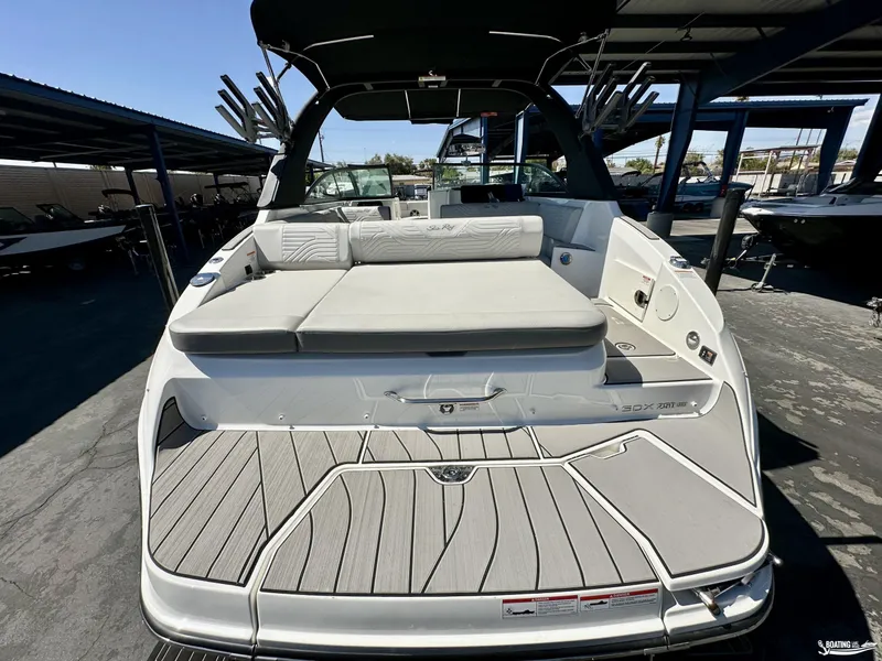 Slide: The Image of 2025 Sea Ray SDX 250 Surf boat with spacious deck and seating area. - 4