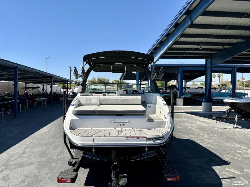Slide: The Image of 2025 Sea Ray SDX 250 Surf boat in a marina under blue skies. - 5