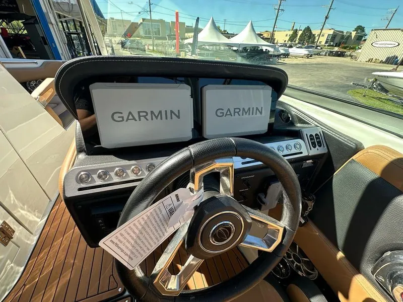Slide: The Image of 2025 Crownline 270 SS boat dashboard with Garmin navigation displays. - 11