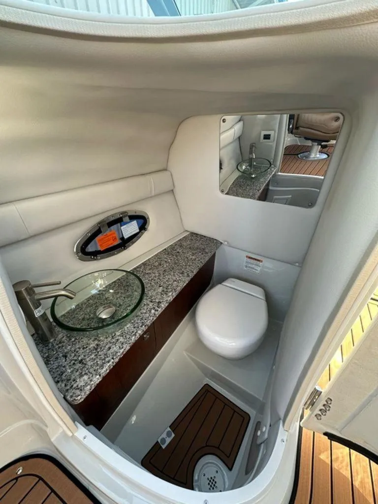 Slide: The Image of Luxurious bathroom interior of 2025 Crownline 270 SS boat with modern fixtures. - 14