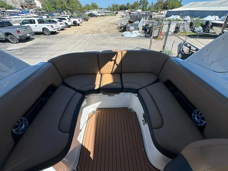 Slide: The Image of 2025 Crownline 270 SS boat interior with brown seating and wood flooring. - 16