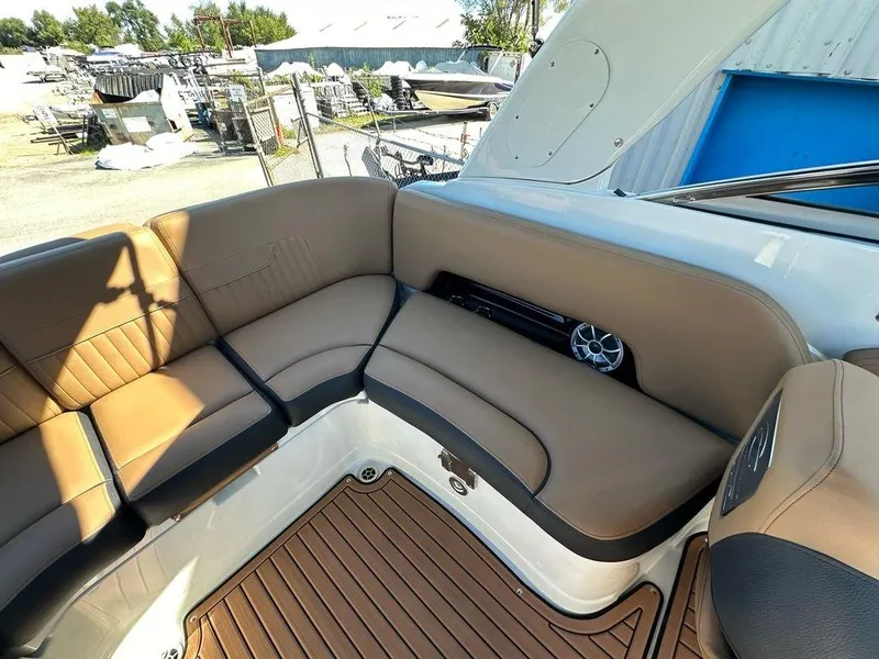 Slide: The Image of 2025 Crownline 270 SS boat interior with tan leather seating and wood-style flooring. - 18