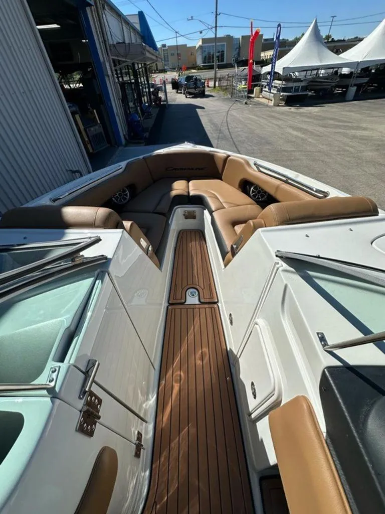 Slide: The Image of 2025 Crownline 270 SS boat interior with tan seating and wood flooring. - 5