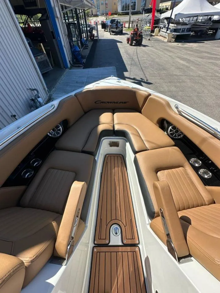 Slide: The Image of 2025 Crownline 270 SS boat interior with tan leather seating and wood accents. - 6
